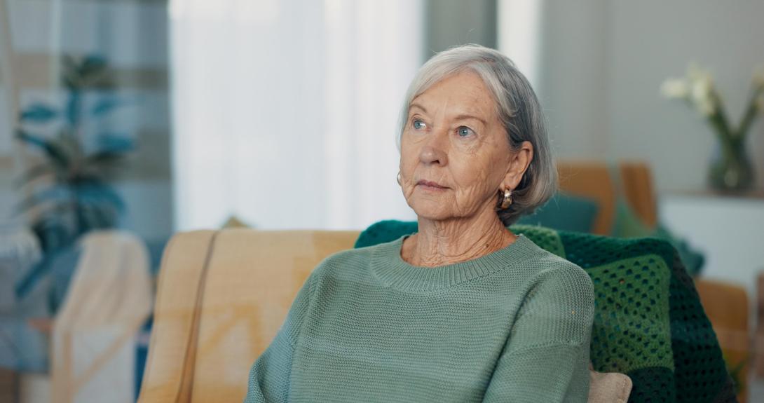 Een oude vrouw die uit het raam kijkt